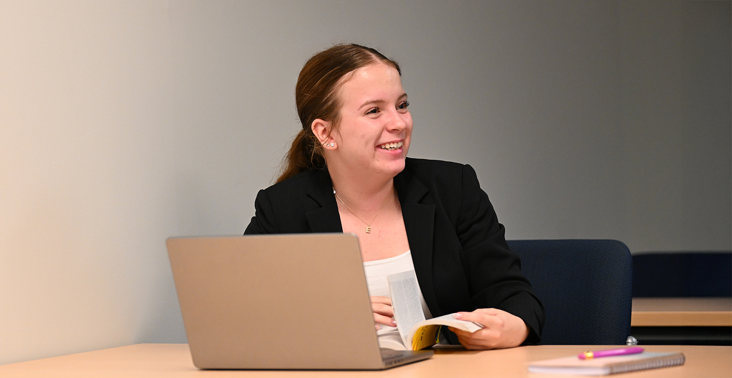Female student with a laptop.