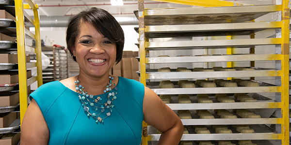 Tamara Turner standing in front of pastries.