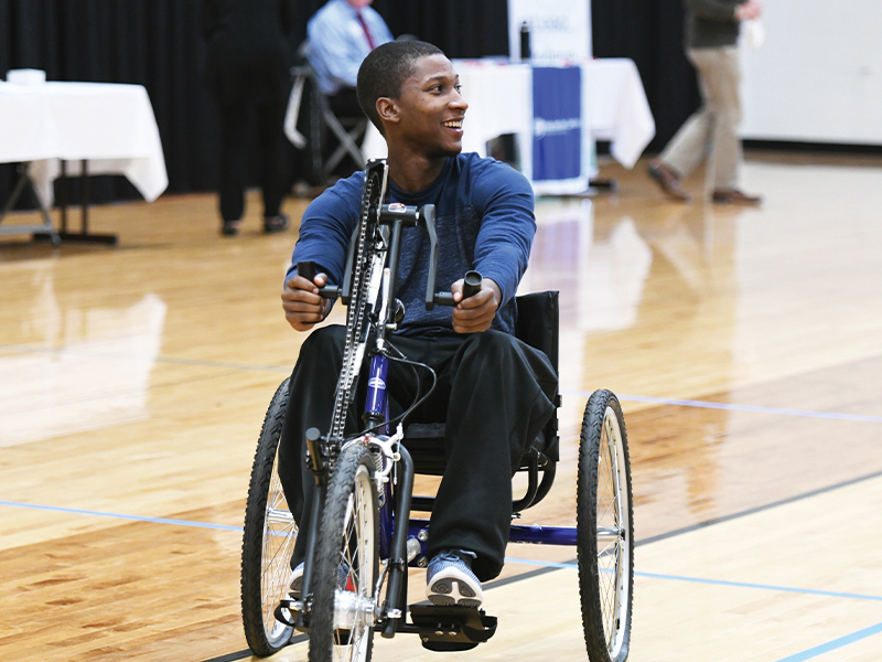 student using an adaptive bike