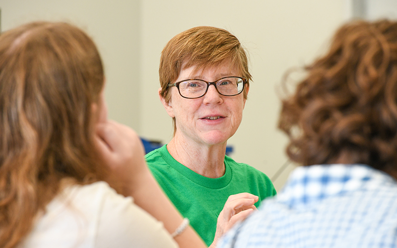 Faculty working with students.